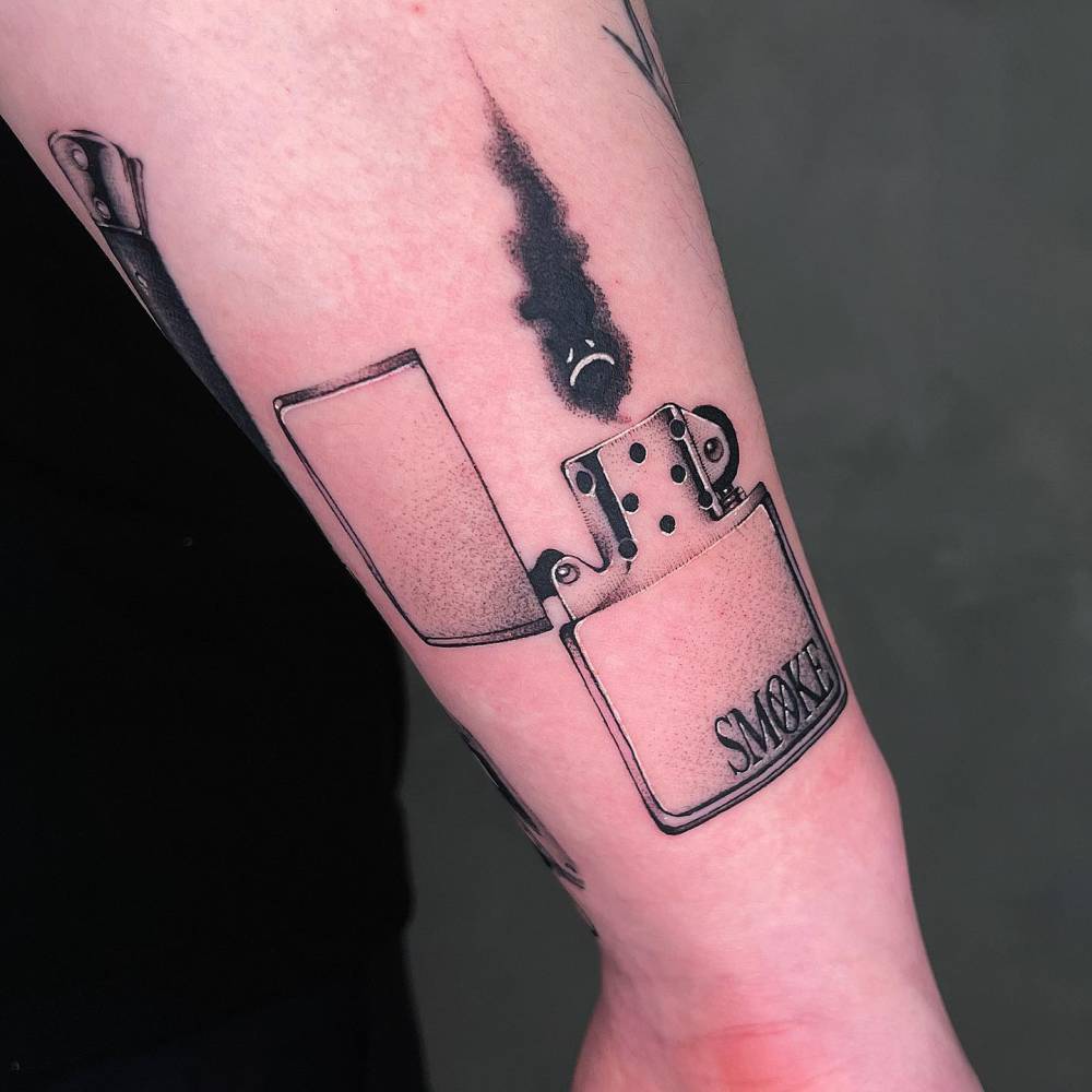 Lighter tattoo in illustrative style located on the forearm.