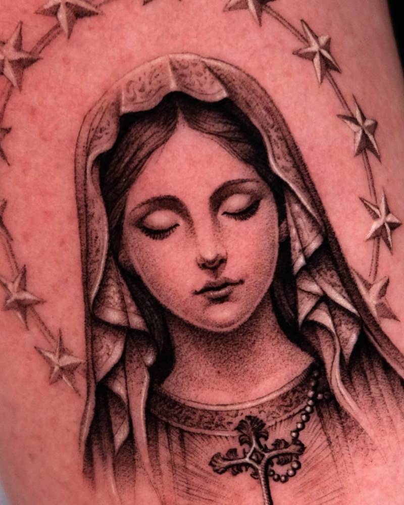 Micro-realistic style Virgin Mary portrait tattoo placed on the forearm.