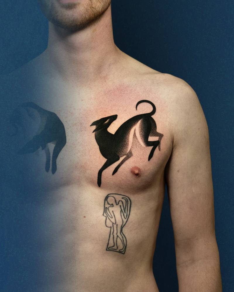 Greyhound tattoo located on the chest, blackwork style.