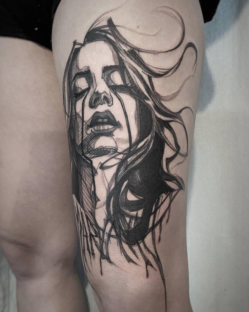 Blackwork style woman portrait tattoo done on the thigh.
