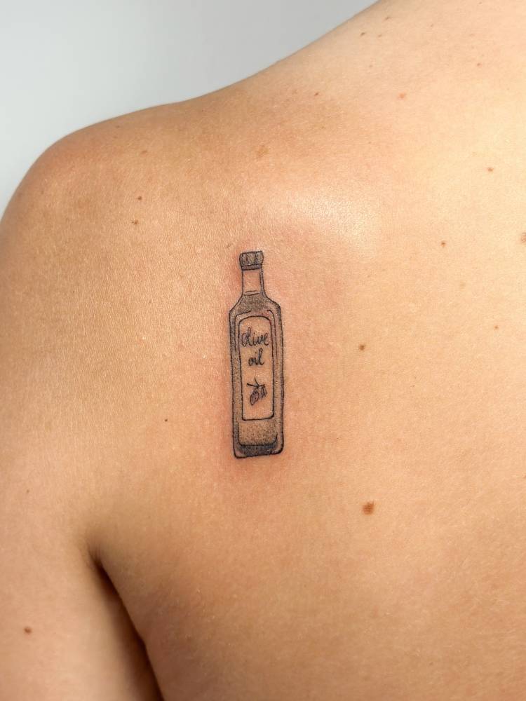 Olive oil tattoo in illustrative style done on the shoulder blade.
