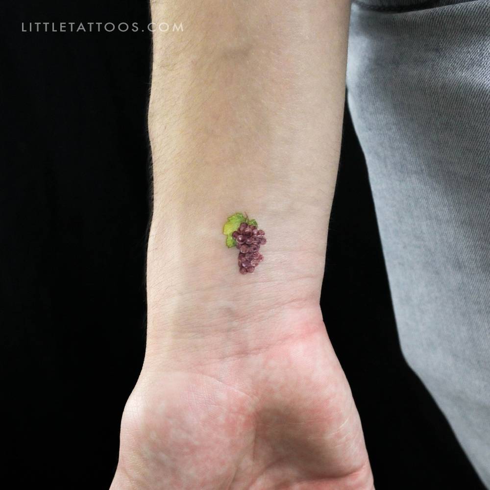 Watercolor style grapes temporary tattoo done on the wrist.