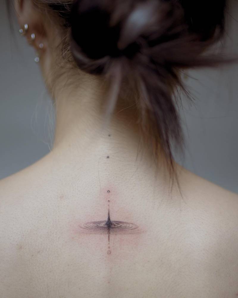 Micro-realistic style water tattoo located on the upper back.