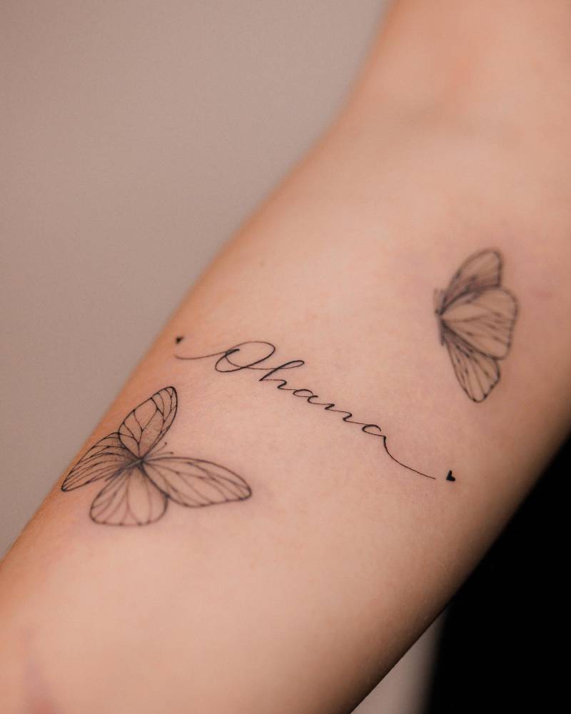 Butterfly couple and "Ohana" script tattoo located on the inner forearm.