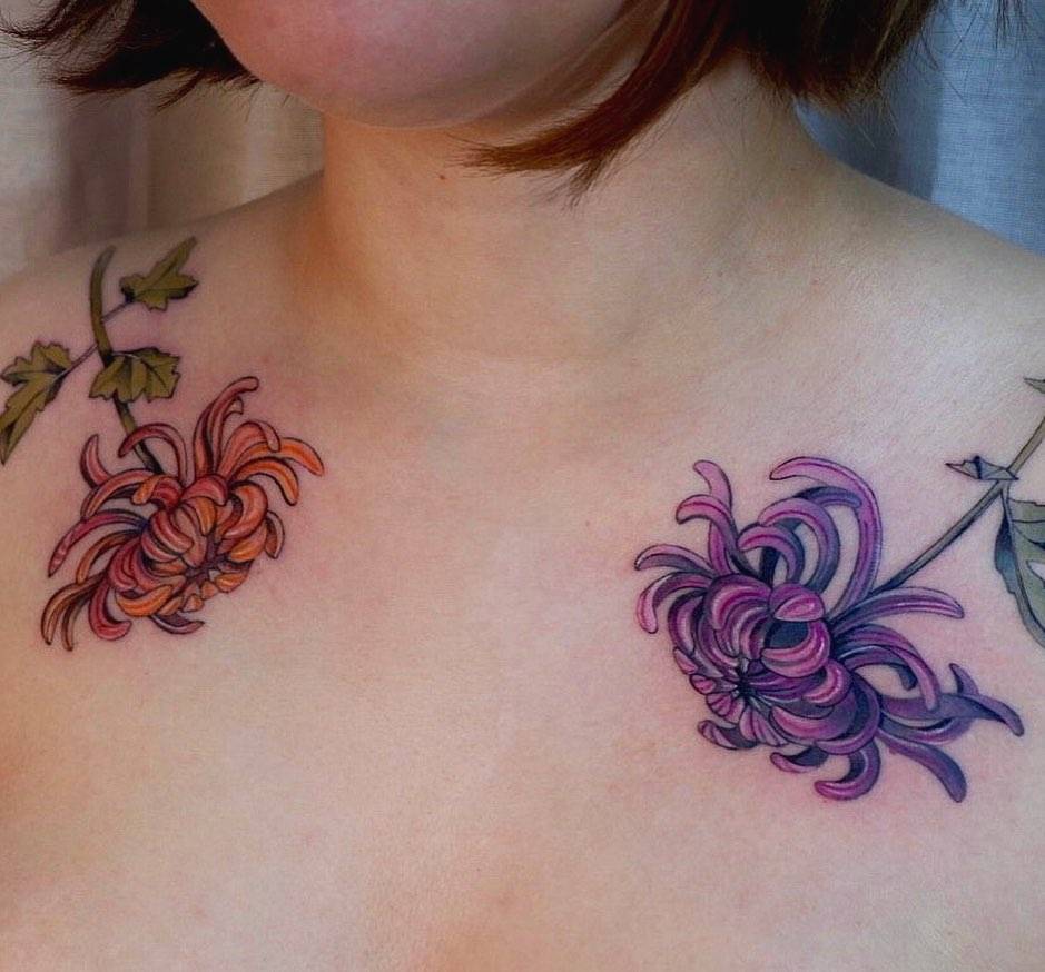 Individual matching chrysanthemums tattoos located on the collarbone.