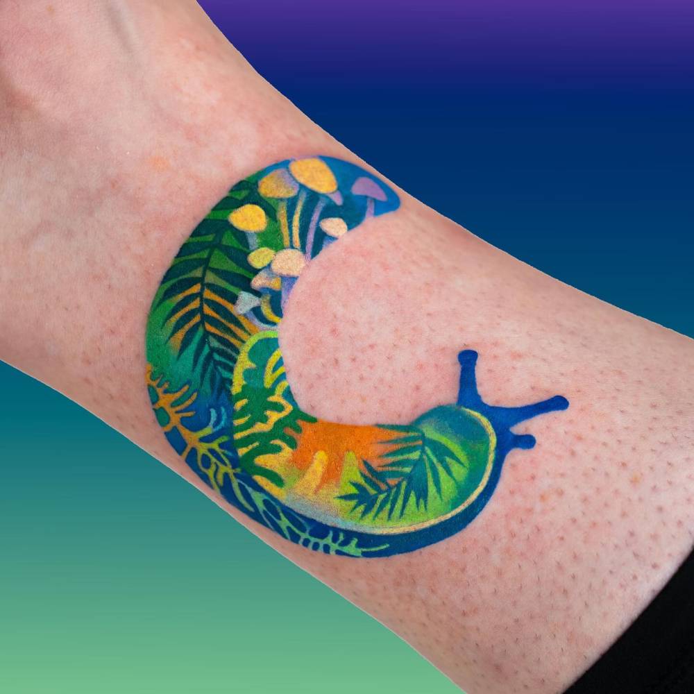 Illustrative style slug tattoo located on the ankle.