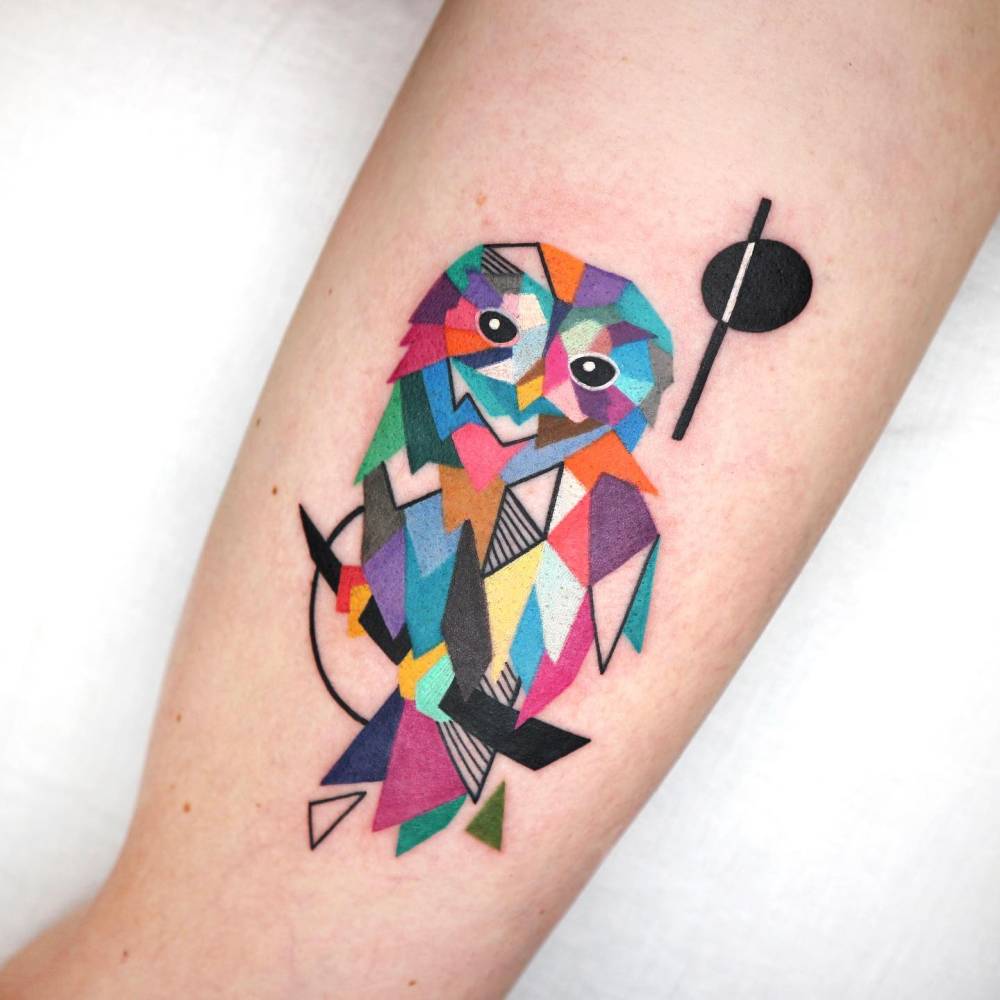 Geometric style barn owl tattoo located on the inner arm.
