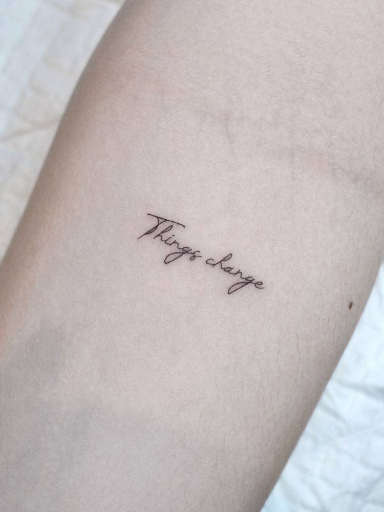 "Things change" lettering tattoo placed on the inner forearm.