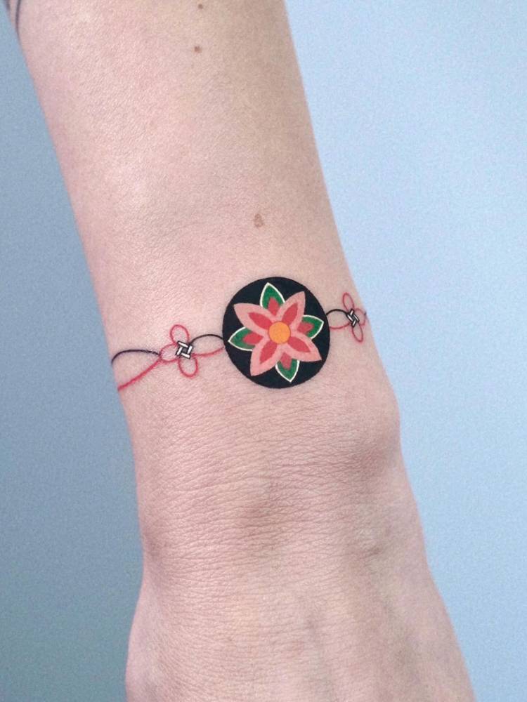 Dancheong bracelet tattoo located on the wrist.