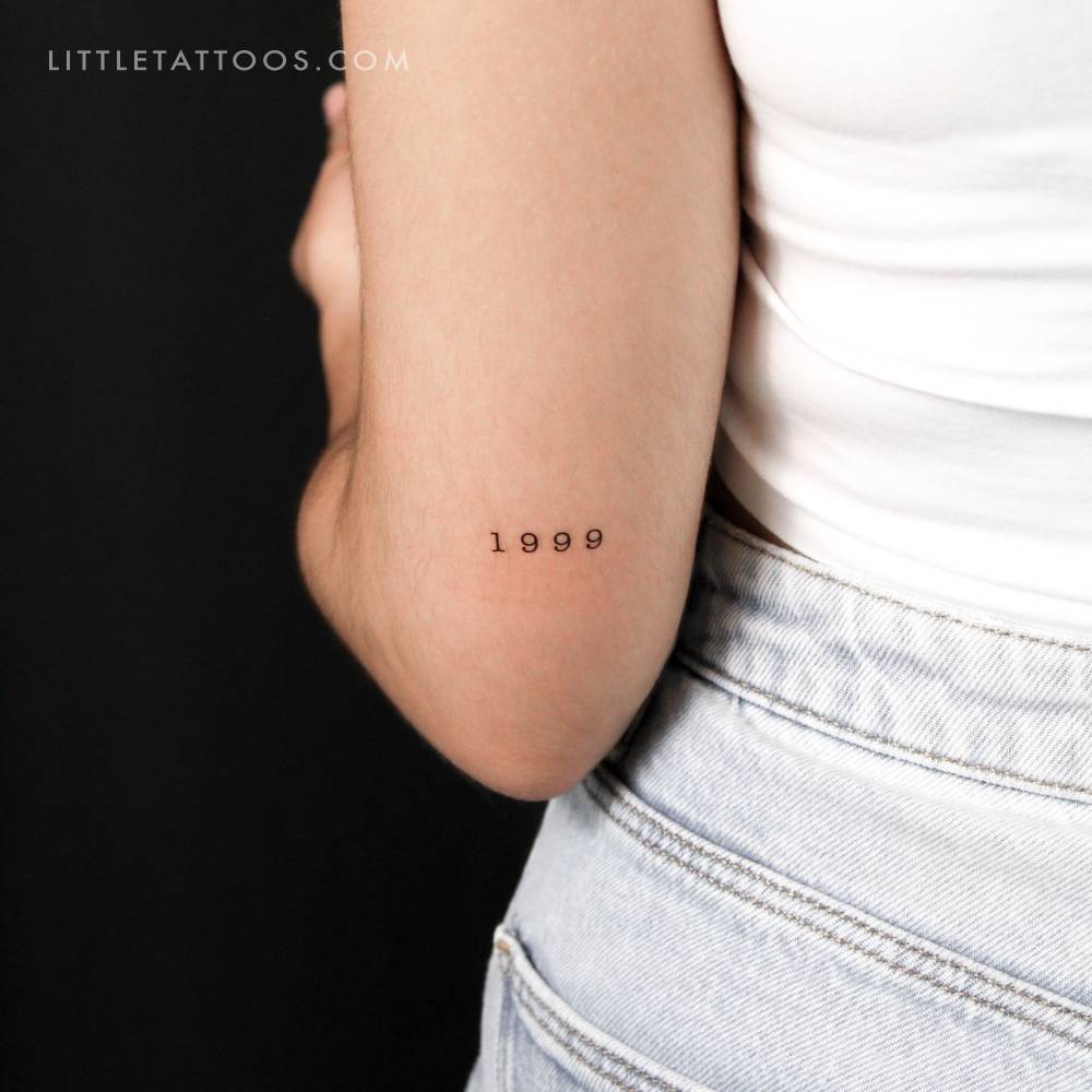 "1999" birth year temporary tattoo located on the tricep.