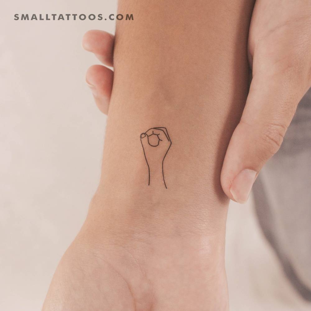 Sign language "O" temporary tattoo located on the wrist.