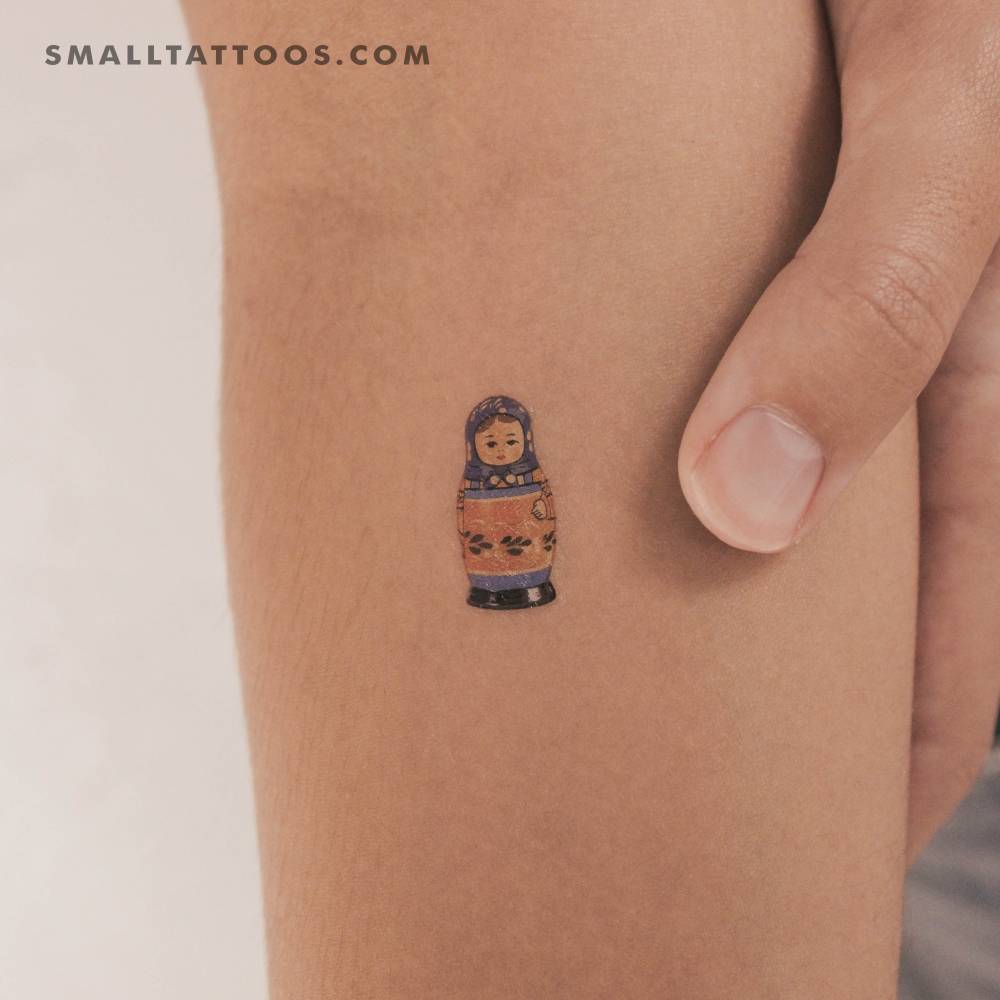 Matryoshka doll temporary tattoo located on the inner forearm.