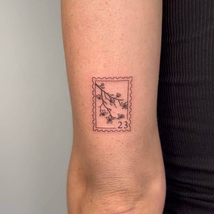 Branch stamp tattoo located on the tricep.