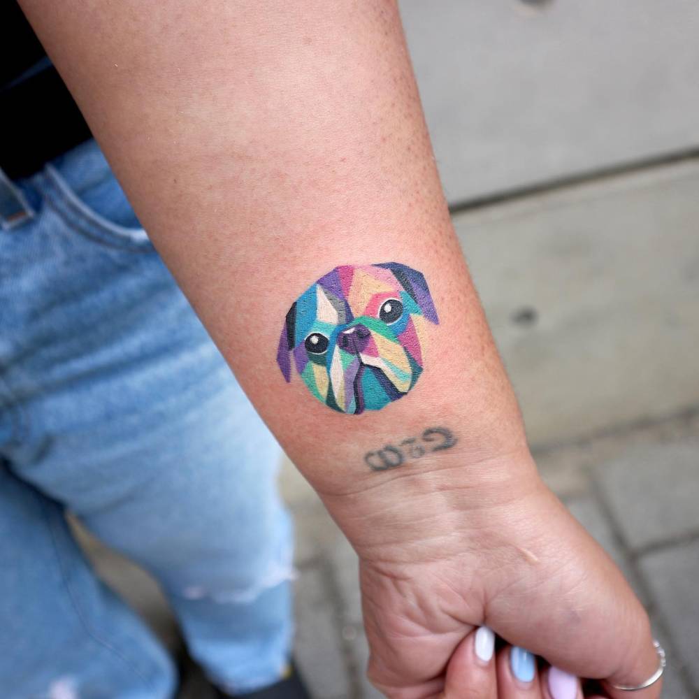 Pug portrait tattoo in pop art style done on the wrist.