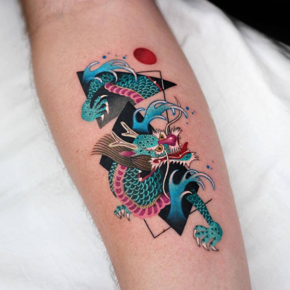 Dragon in graphic style tattooed on the inner forearm.