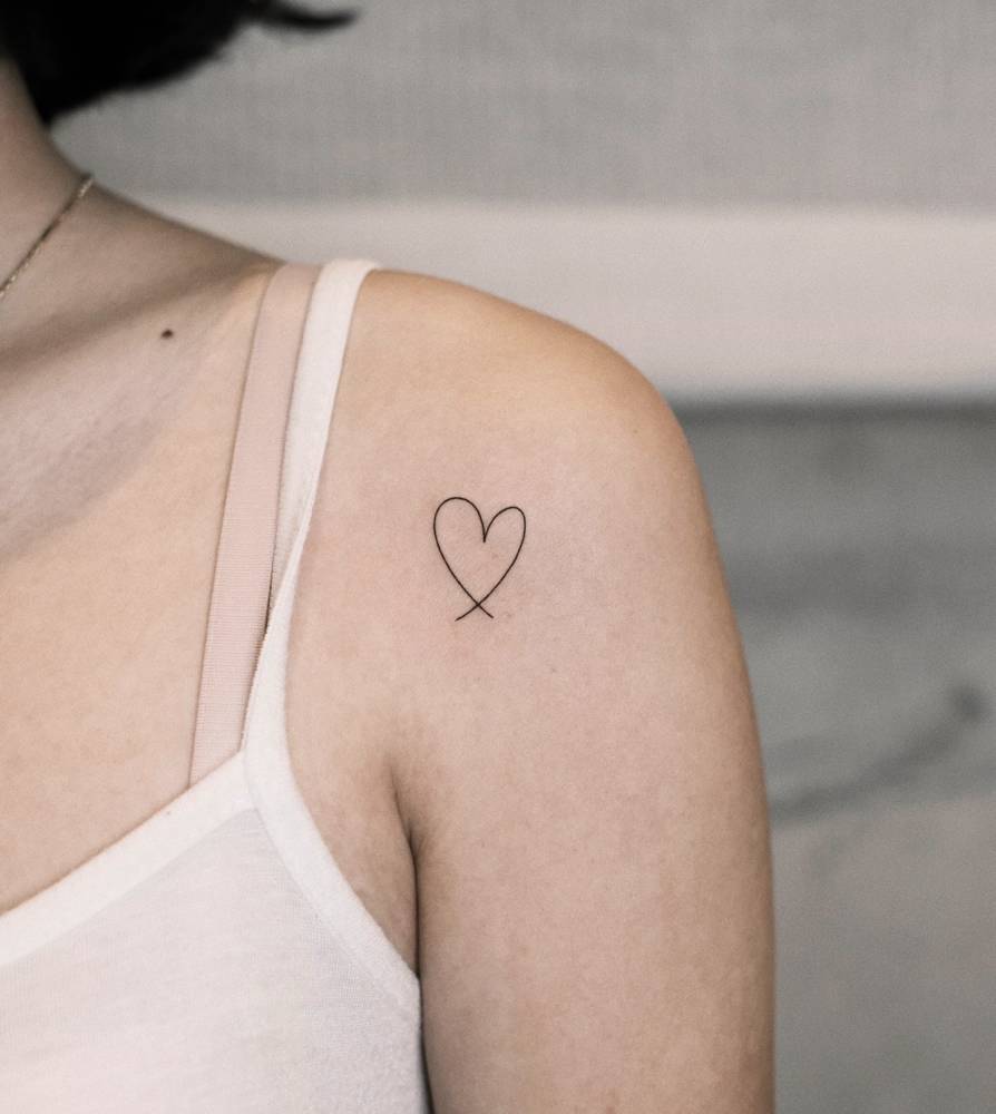 Minimalistic conventional heart tattoo located on the shoulder.