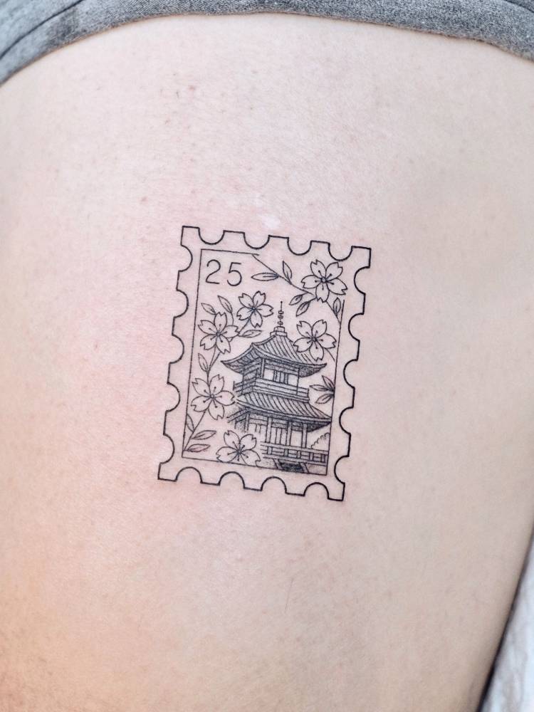 Korean stamp tattoo located on the thigh, done in fine line style.