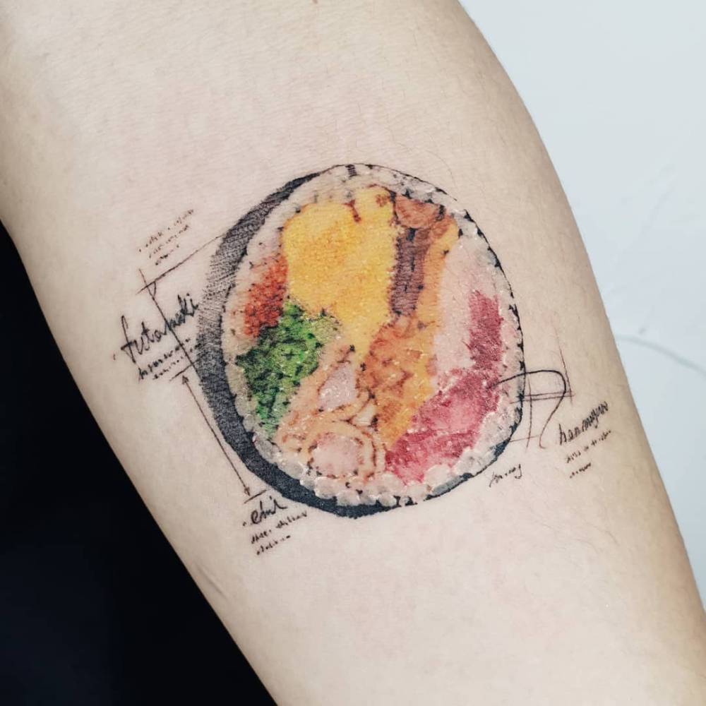 Micro-realistic style Gimbap tattoo located on the inner forearm.