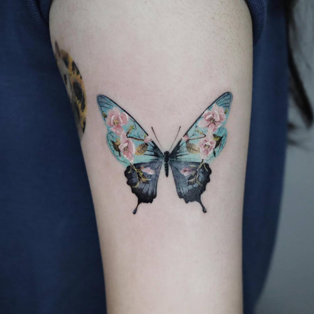 Flower butterfly tattoo in micro-realistic style.