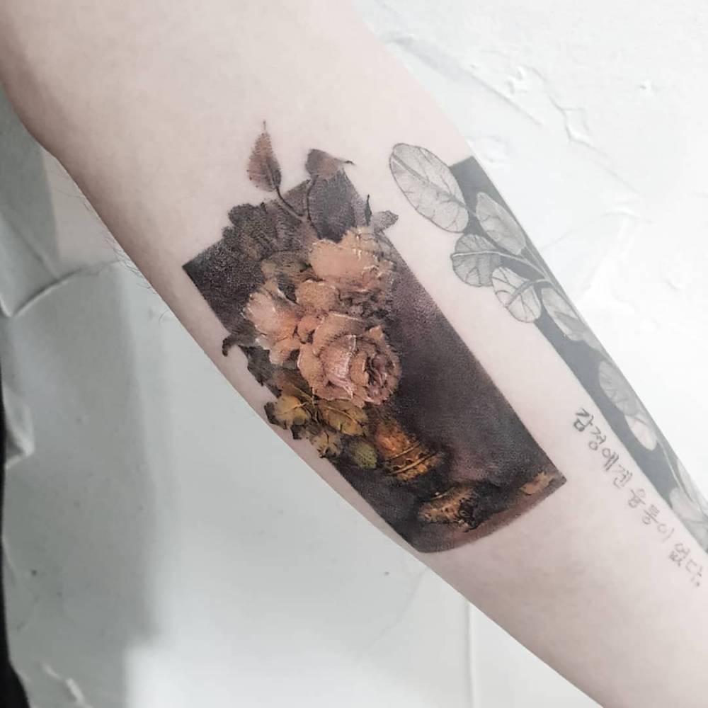 Watercolor style roses tattoo located on the inner forearm.