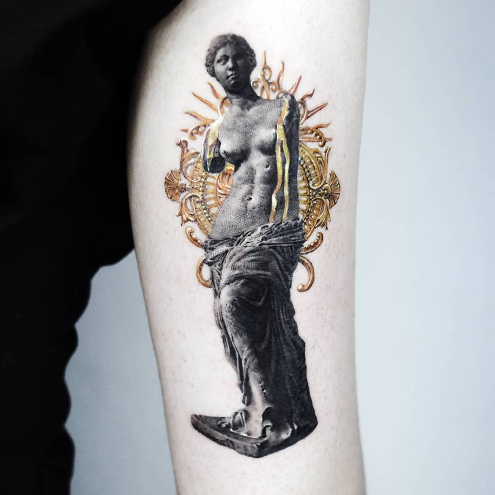 Micro-realistic style Venus de Milo tattoo placed on the tricep.