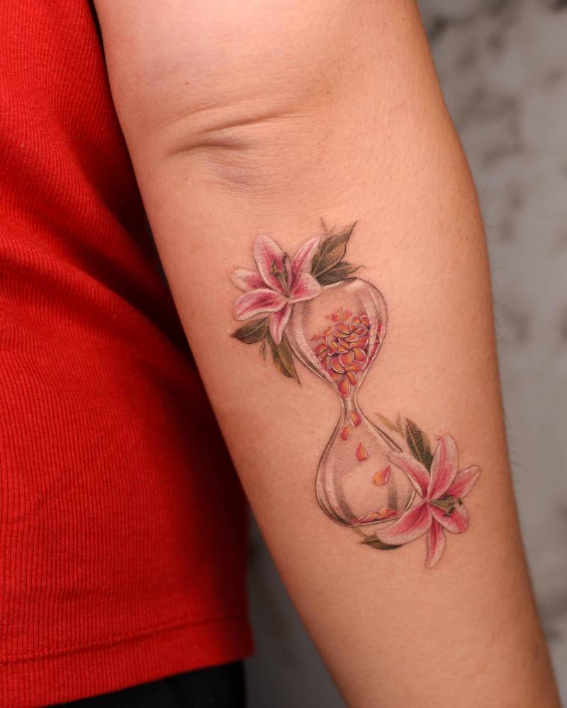 Hourglass tattoo located on the forearm, illustrative style.