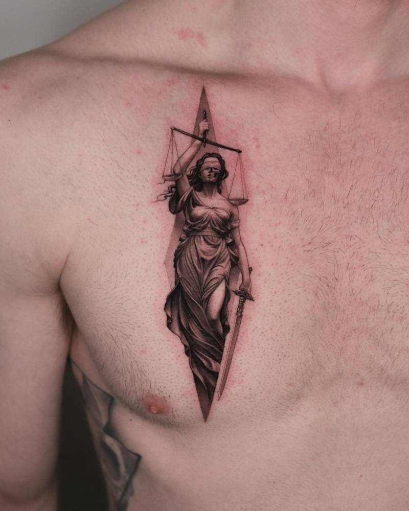 Lady Justice tattoo in micro-realistic style done on the chest.