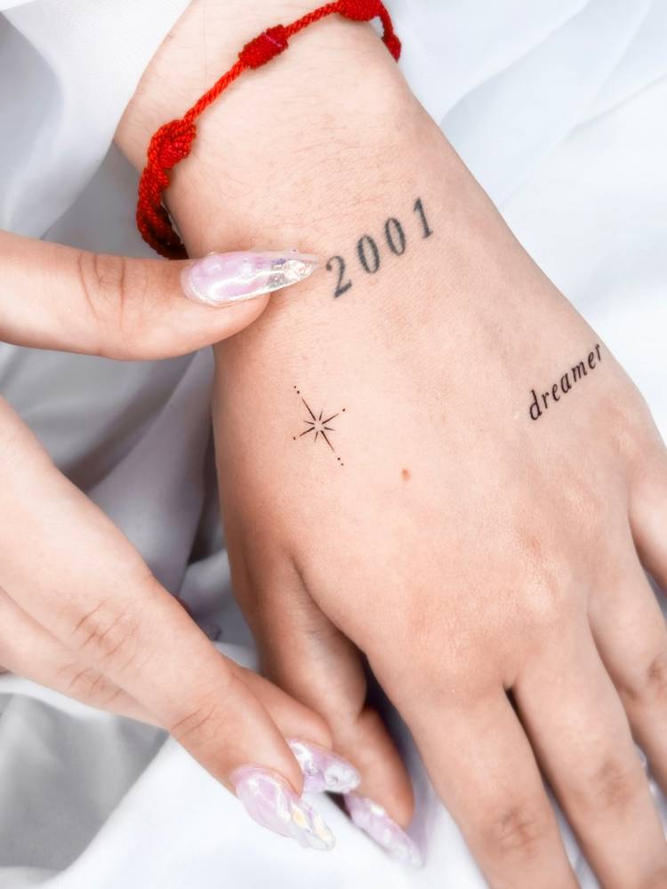 Tiny minimalistic north star tattoo located on the hand.