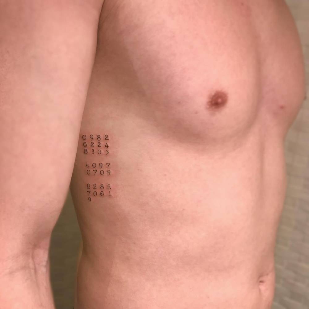 Typewriter font numbers tattoo located on the rib.