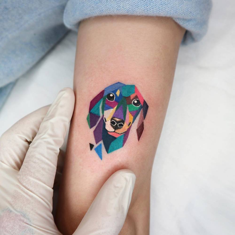 Dachshund portrait tattoo located on the tricep.