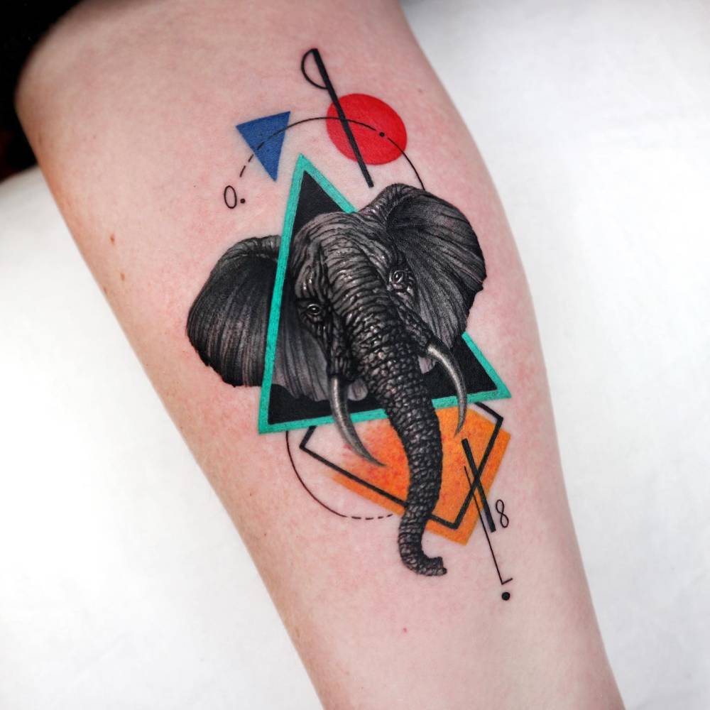 Elephant portrait tattoo located on the inner forearm, graphic style.