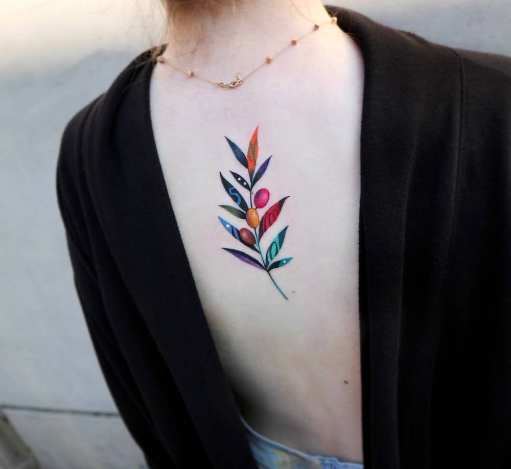 Pop art style olive branch tattoo placed on the upper back,