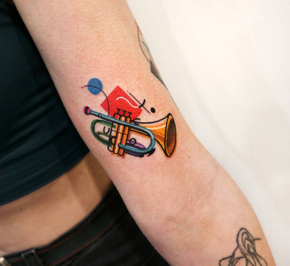 Trumpet tattoo in pop art style done on the bicep.