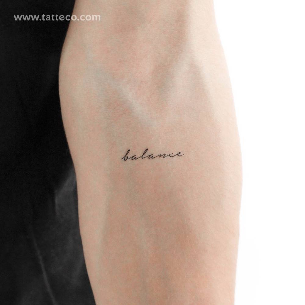 Handwritten font word 'balance' temporary tattoo located on the inner forearm.