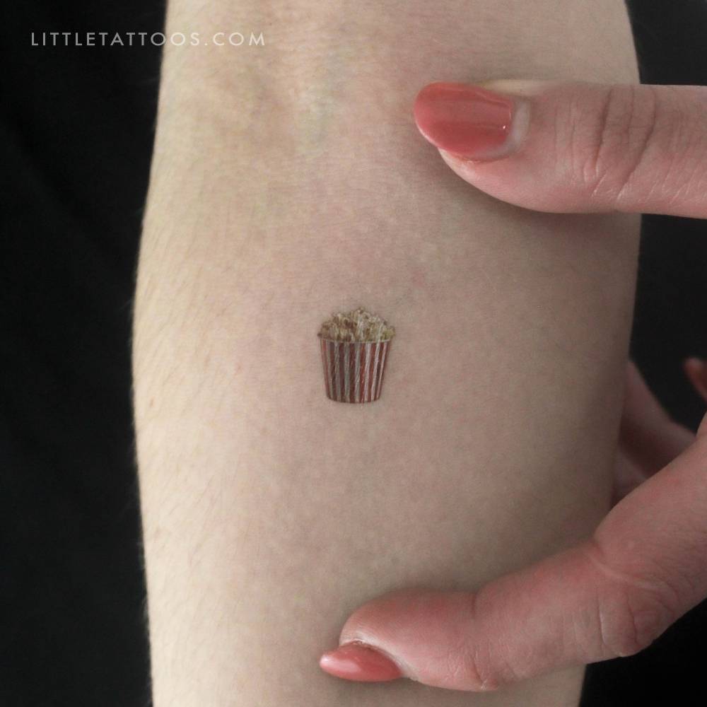 Micro-realistic little popcorn temporary tattoo located on the inner forearm.