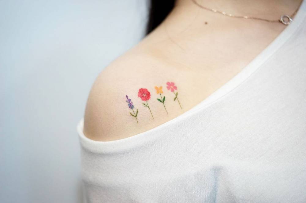 Watercolor flowers tattooed on the shoulder