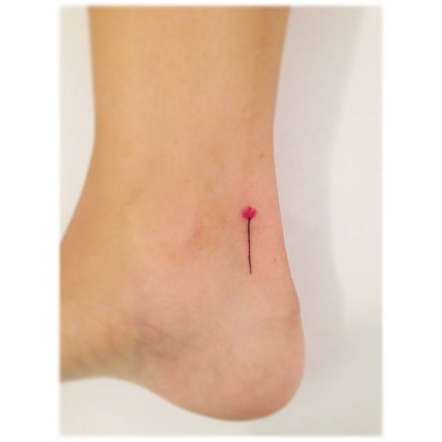 Minimalistic style flower tattoo located on the ankle.