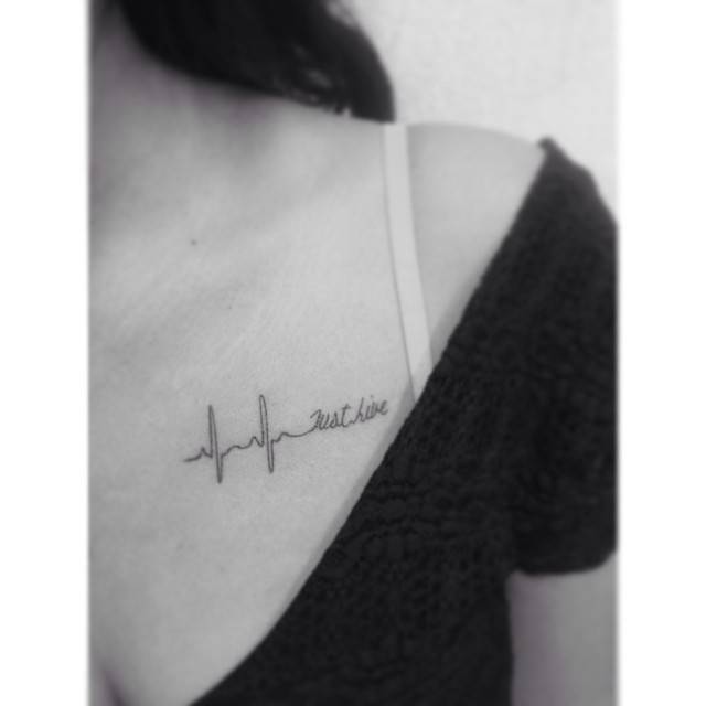 Heartbeats and words "just live" tattooed on the chest.