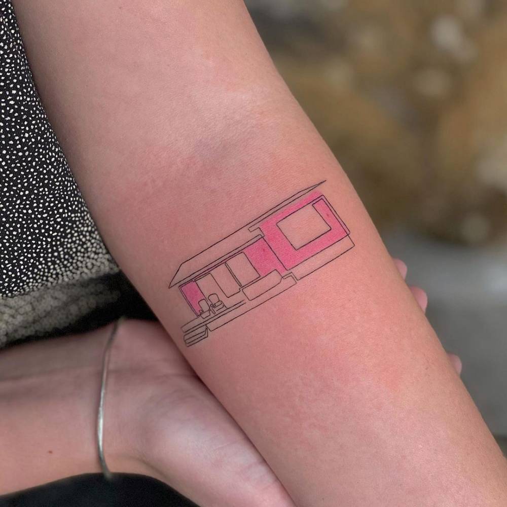 House tattoo in illustrative style located on the inner forearm.