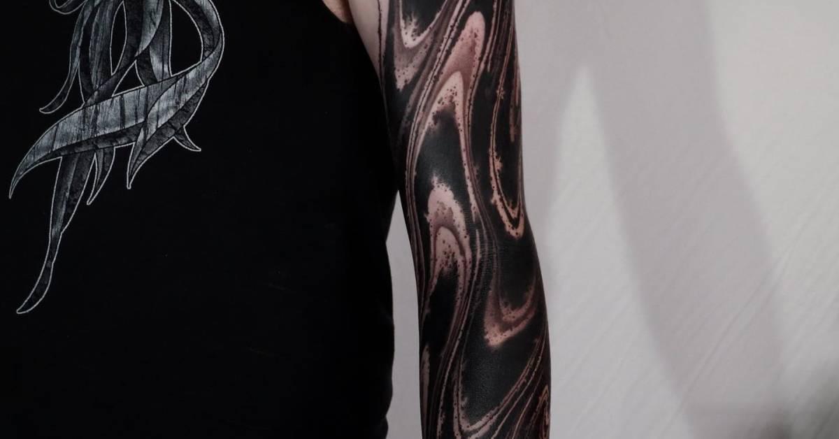 Abstract tattoo sleeve done in blackwork style.