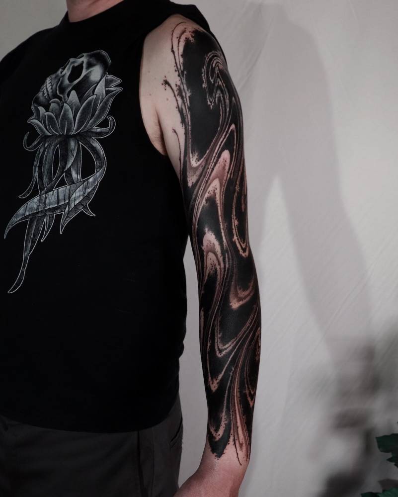 Abstract tattoo sleeve done in blackwork style.