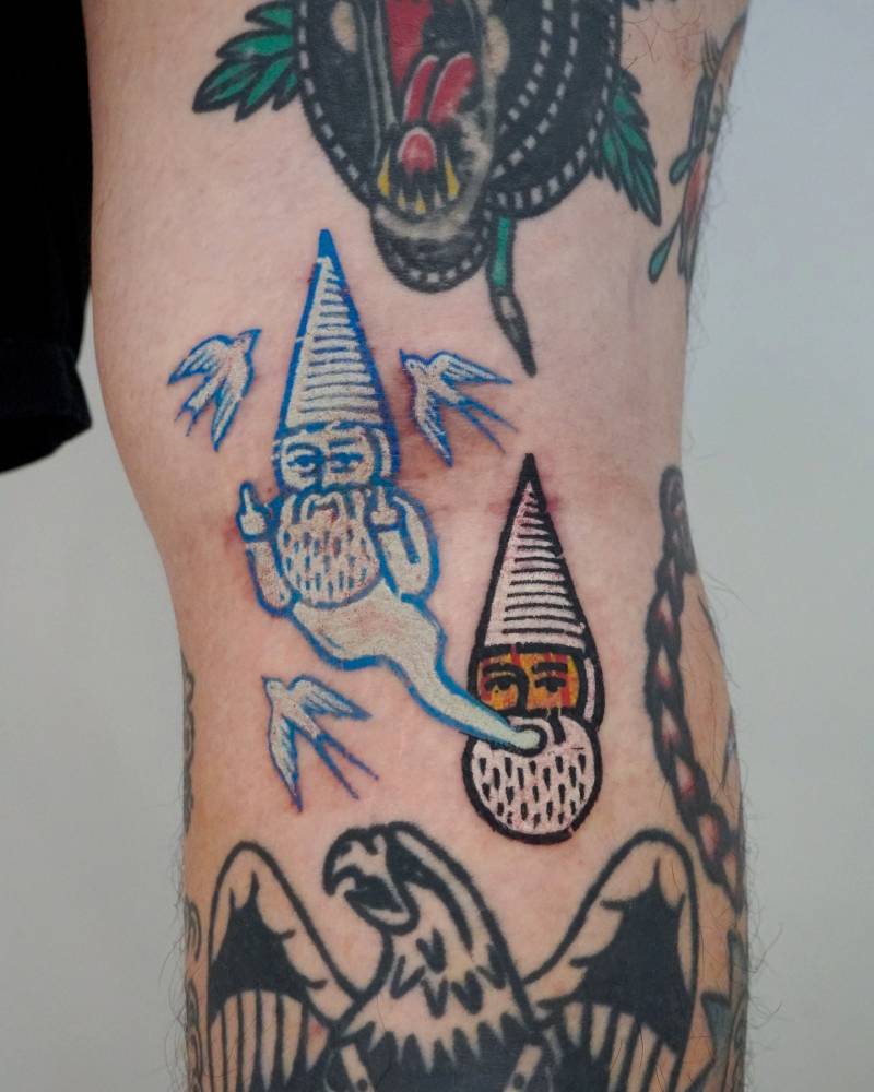 Pop art style gnome tattoo located on the leg.