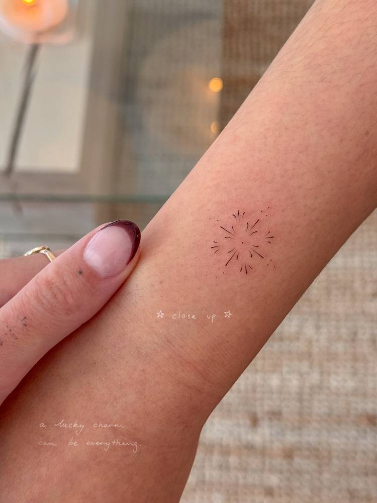 Little ornamental tattoo located on the wrist.