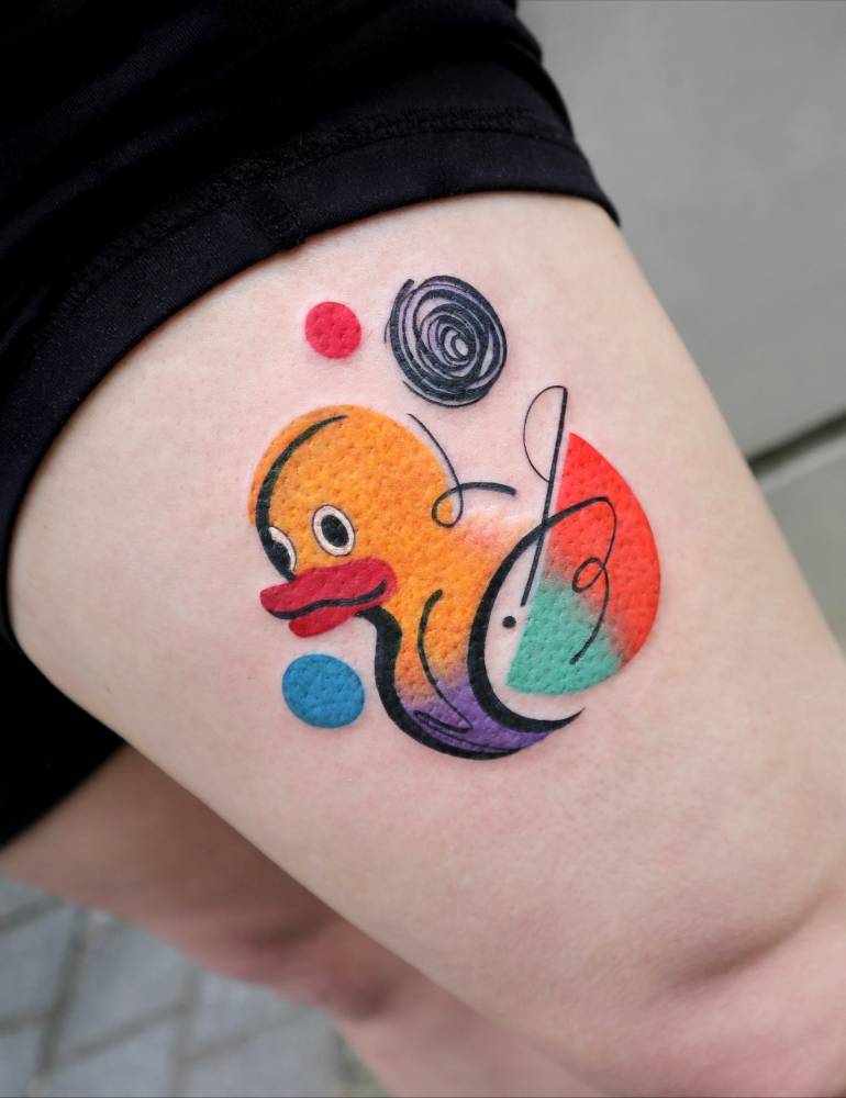 Rubber duck tattoo in pop art style done on the thigh.