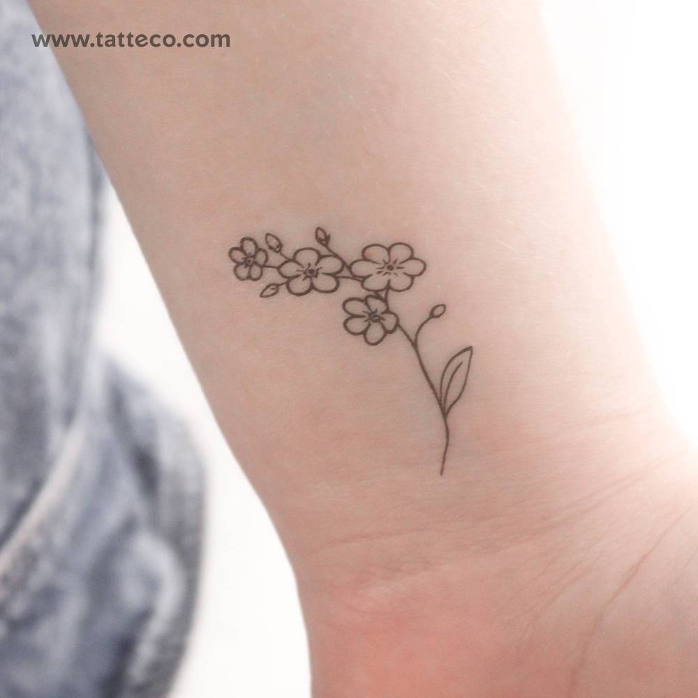 Fine line forget-me-not temporary tattoo located on the wrist.