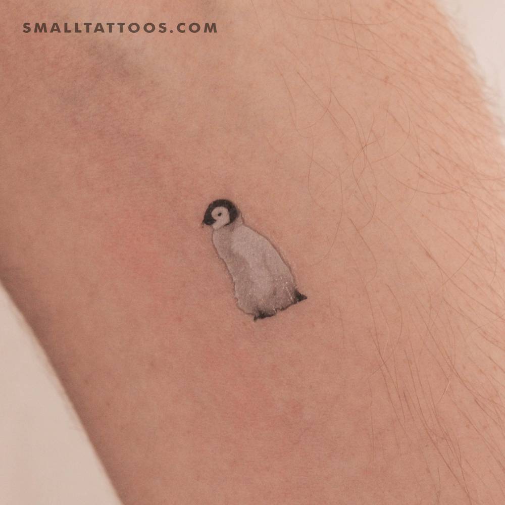 Baby penguin temporary tattoo located on the inner forearm.