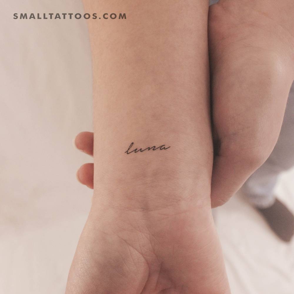 Handwritten font word "luna" temporary tattoo located on the wrist.