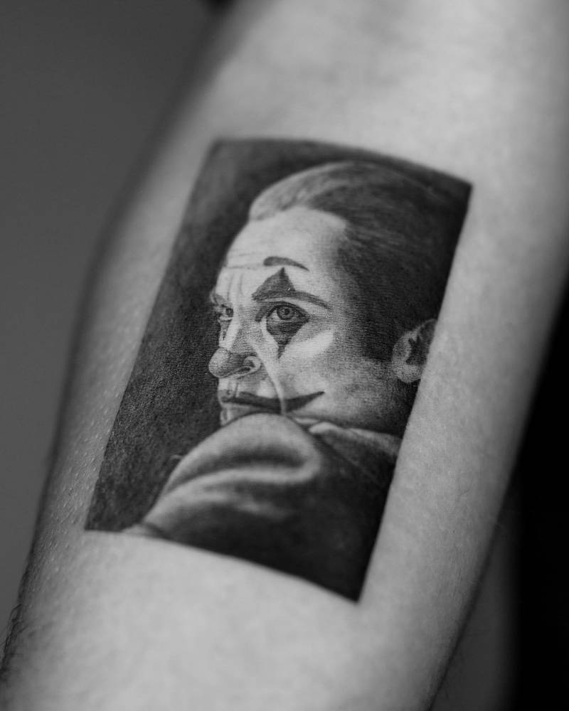 Micro-realistic style The Joker tattoo located on the inner forearm.