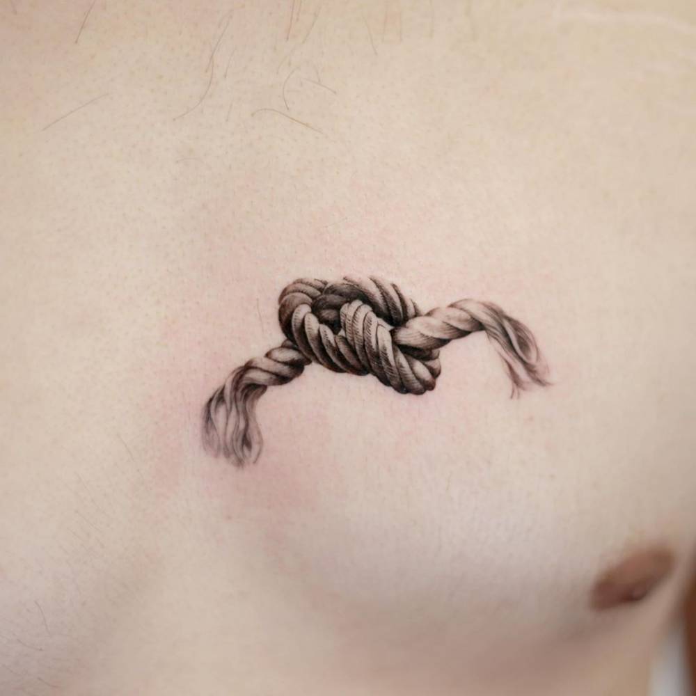 Rope tattoo in micro-realistic style located on the chest.