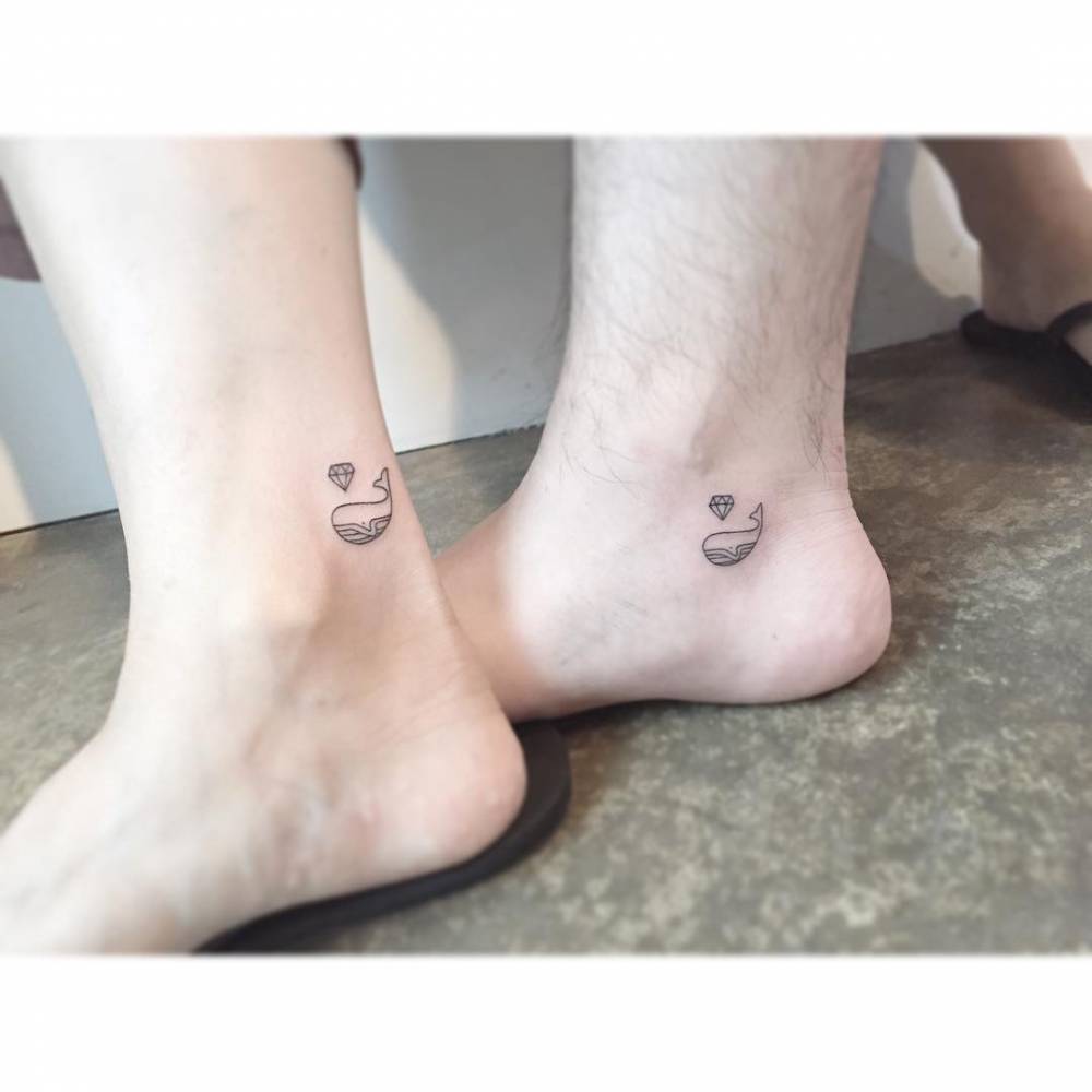 Matching whale and diamond tattoo for couple.